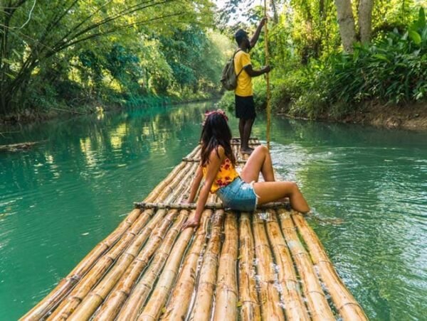 Raft captain and Woman rafting on the Martha Brae River in Jamaica